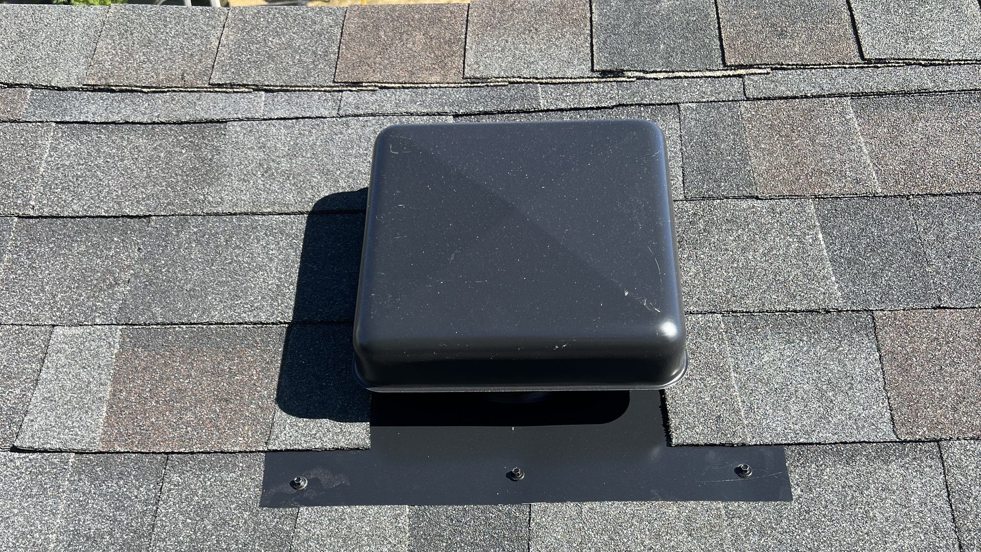 Attic exhaust vent installed with gasketed screws on an asphalt shingle roof by Evolution RoofWorks, Portland Oregon