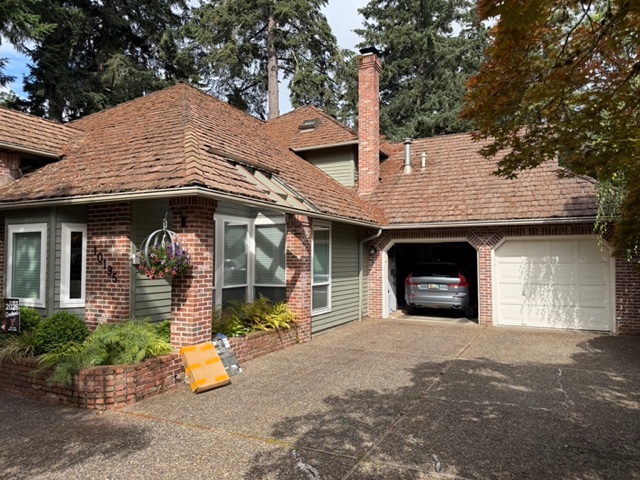 Weathered original cedar shake roof on a brick Tualatin, Oregon home before replacement